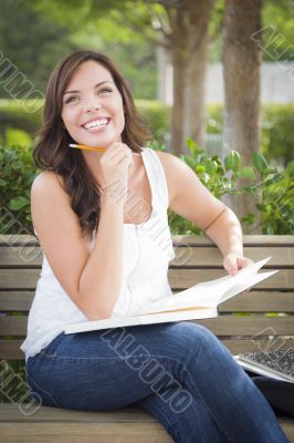 Young Adult Female Student on Bench Outdoors