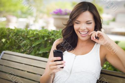 Young Adult Female Texting on Cell Phone Outdoors