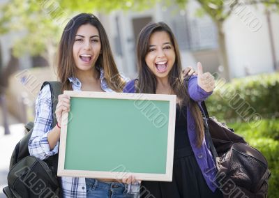 Mixed Race Female Students with Thumbs Up Holding Blank Chalkboa