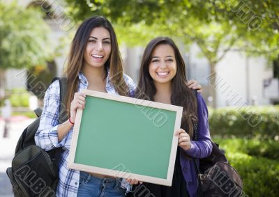 Mixed Race Female Students Holding Blank Chalkboard