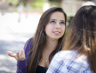 Expressive Young Mixed Race Female Sitting and Talking with Girl