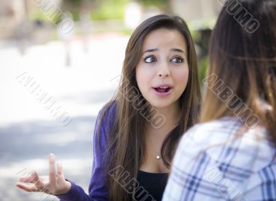 Expressive Young Mixed Race Female Sitting and Talking with Girl