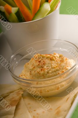 hummus dip with pita bread and vegetable