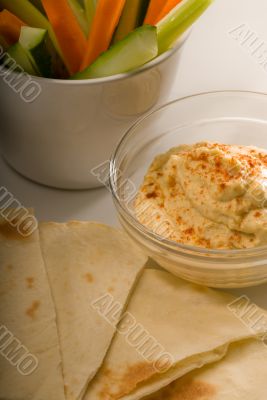 hummus dip with pita bread and vegetable