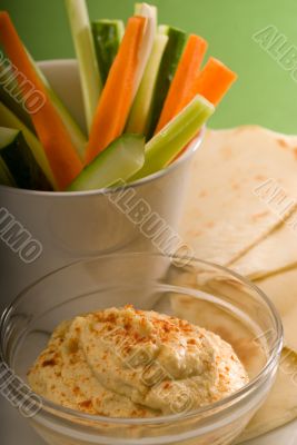 hummus dip with pita bread and vegetable