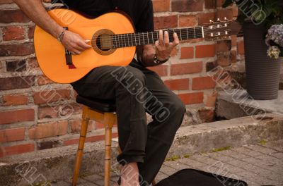 Street musician playing with guitar