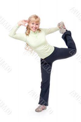 Young girl doing stretching exercises for the legs. Isolate on w