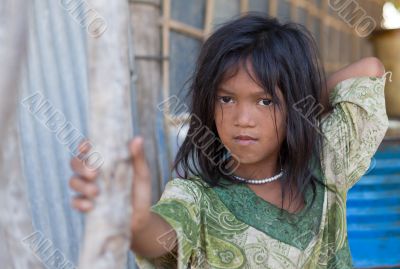 A young girl lives in a fishing village and tourist poses for a 