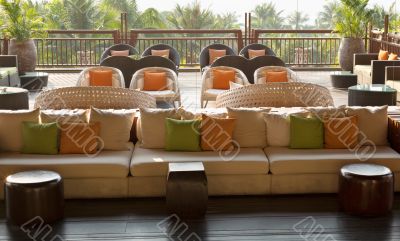 cafe with sofas and cushions, palm