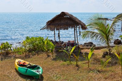 Plastic kayak on the shore next to the hut