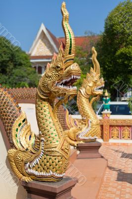 Thai golden dragon guards the entrance to the temple