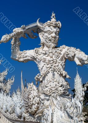 sculpture soldier guards the entrance to the White temple