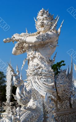 sculpture soldier guards the entrance to the white temple in Chi