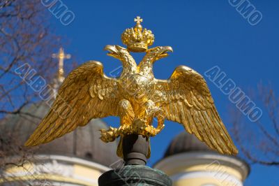 golden double-headed eagle on a background of blue sky