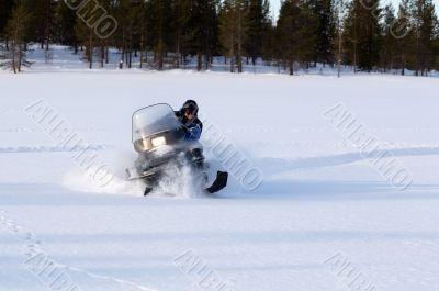 man riding a snowmobile