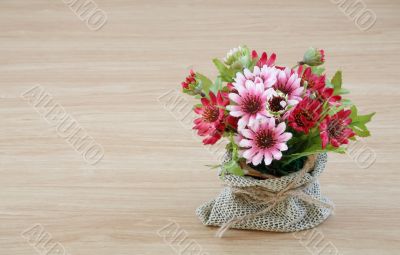 Decorative flower on wooden desk Decorative flower on wooden desk