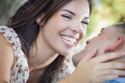 Mixed Race Romantic Couple Kissing in the Park Mixed Race Romantic Couple Kissing in the Park