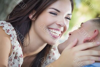 Mixed Race Romantic Couple Kissing in the Park