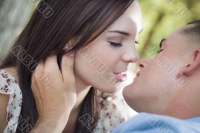 Mixed Race Romantic Couple Kissing in the Park