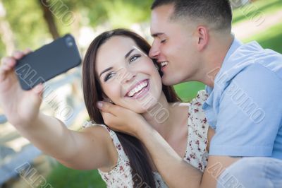 Mixed Race Couple Taking Self Portrait in Park Mixed Race Couple Taking Self Portrait in Park