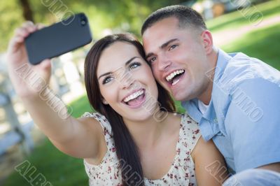 Mixed Race Couple Taking Self Portrait in Park