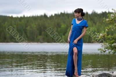girl in a luxurious evening dress on the lake