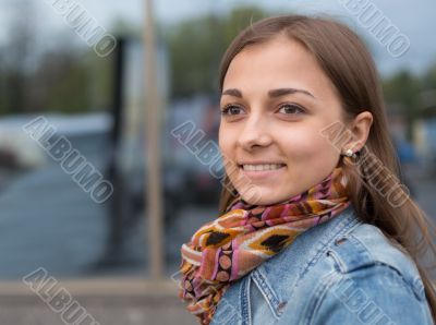 portrait of a beautiful girl in a denim jacket with a scarf