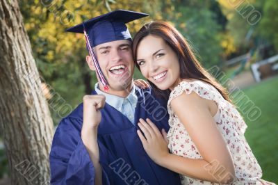 Male Graduate in Cap and Gown and Girl Celebrate