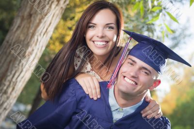 Male Graduate in Cap and Gown and Girl Celebrate