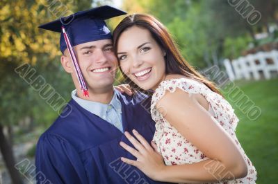 Male Graduate in Cap and Gown and Girl Celebrate