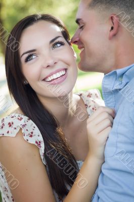 Mixed Race Romantic Couple Whispering in the Park