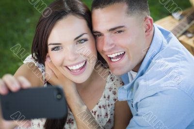 Mixed Race Couple Taking Self Portrait in Park