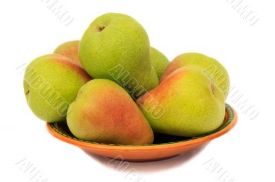 Ripe pears on the plate on a white background.