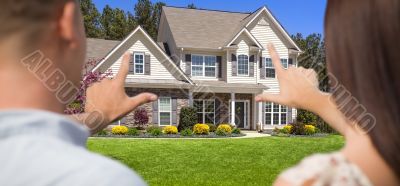 House and Military Couple Framing Hands in Front