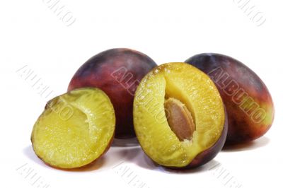 Large ripe plums on a white background.