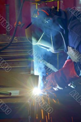 welder with protective mask welding metal