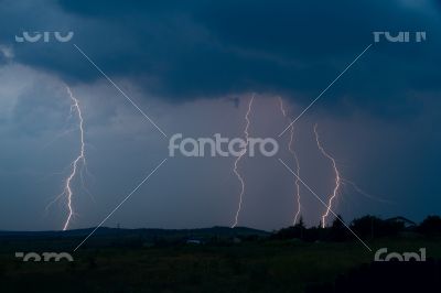 Lightning bolt striking in the sky from clouds