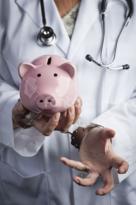 Doctor In Handcuffs Holding Piggy Bank Wearing Lab Coat, Stethos