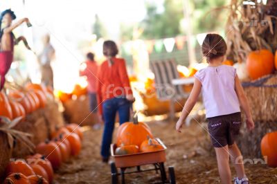 Two Little Girls Pulling Their Pumpkins In A Wagon