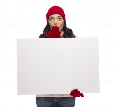 Stunned Girl Wearing Winter Hat and Gloves Holds Blank Sign 