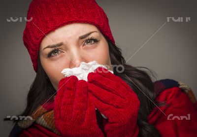 Sick Mixed Race Woman Blowing Her Sore Nose With Tissue