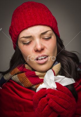 Sick Mixed Race Woman Blowing Her Sore Nose With Tissue