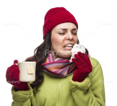 Sick Mixed Race Woman Drinks Hot Tea While Blowing Nose 