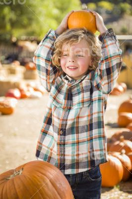 Little Boy Holding His Pumpkin at a Pumpkin Patch