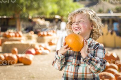 Little Boy Holding His Pumpkin at a Pumpkin Patch