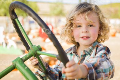 Adorable Young Boy Playing on an Old Tractor Outside