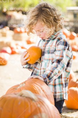 Little Boy Holding His Pumpkin at a Pumpkin Patch