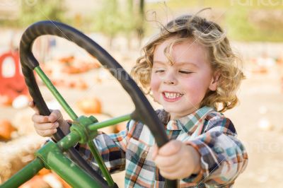 Adorable Young Boy Playing on an Old Tractor Outside Adorable Young Boy Playing on an Old Tractor Outside