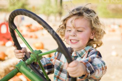 Adorable Young Boy Playing on an Old Tractor Outside