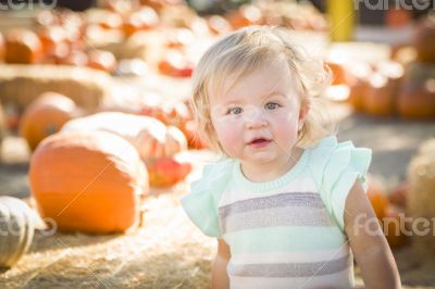 Adorable Baby Girl Having Fun at the Pumpkin Patch